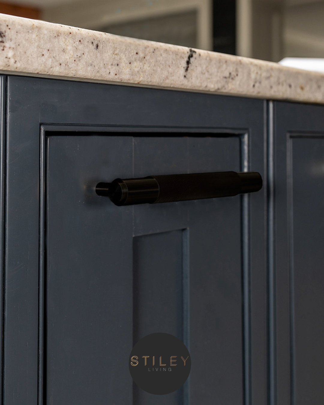 Brass handle on a blue cabinet door
