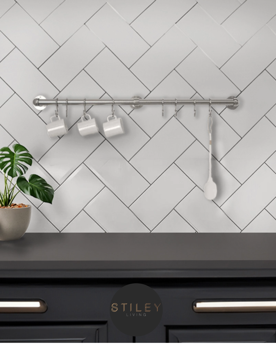 Utensil rail Silver utensil rail on a white tiled kitchen wall